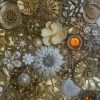 Natural wooden table showcasing a collection of the most exquisite original vintage floral jewellery, from 1940’s -1990’s encased in resin.
