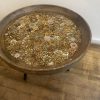Natural wooden table showcasing a collection of the most exquisite original vintage floral jewellery, from 1940’s -1990’s encased in resin.