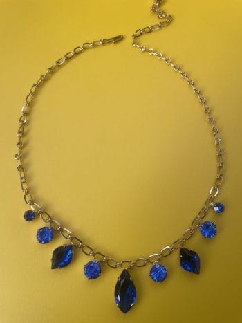 Gold plated necklace from 1960s featuring blue crystal adjustable